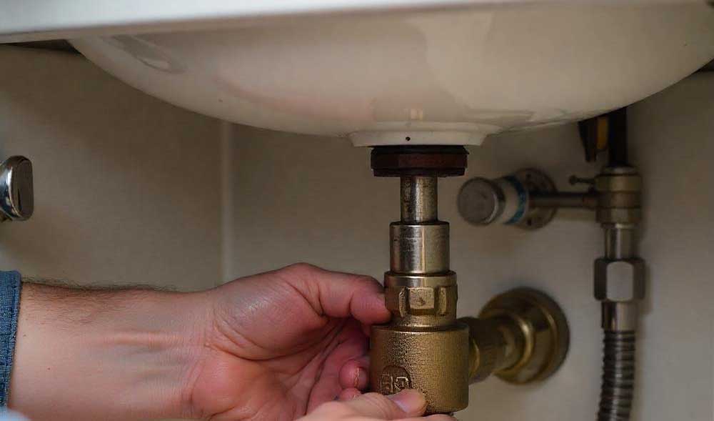 hand turning off valve under the sink