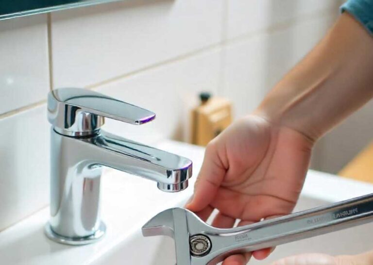 person fixing bathroom faucet